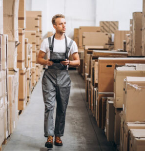 young-man-working-warehouse-with-boxes_1303-16597