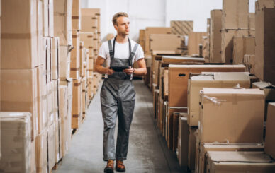 young-man-working-warehouse-with-boxes_1303-16597